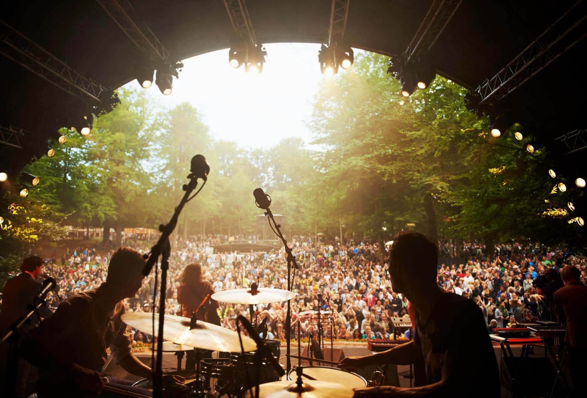 Vue depuis la scène d'un festival de musique devant un public réuni en plein air.